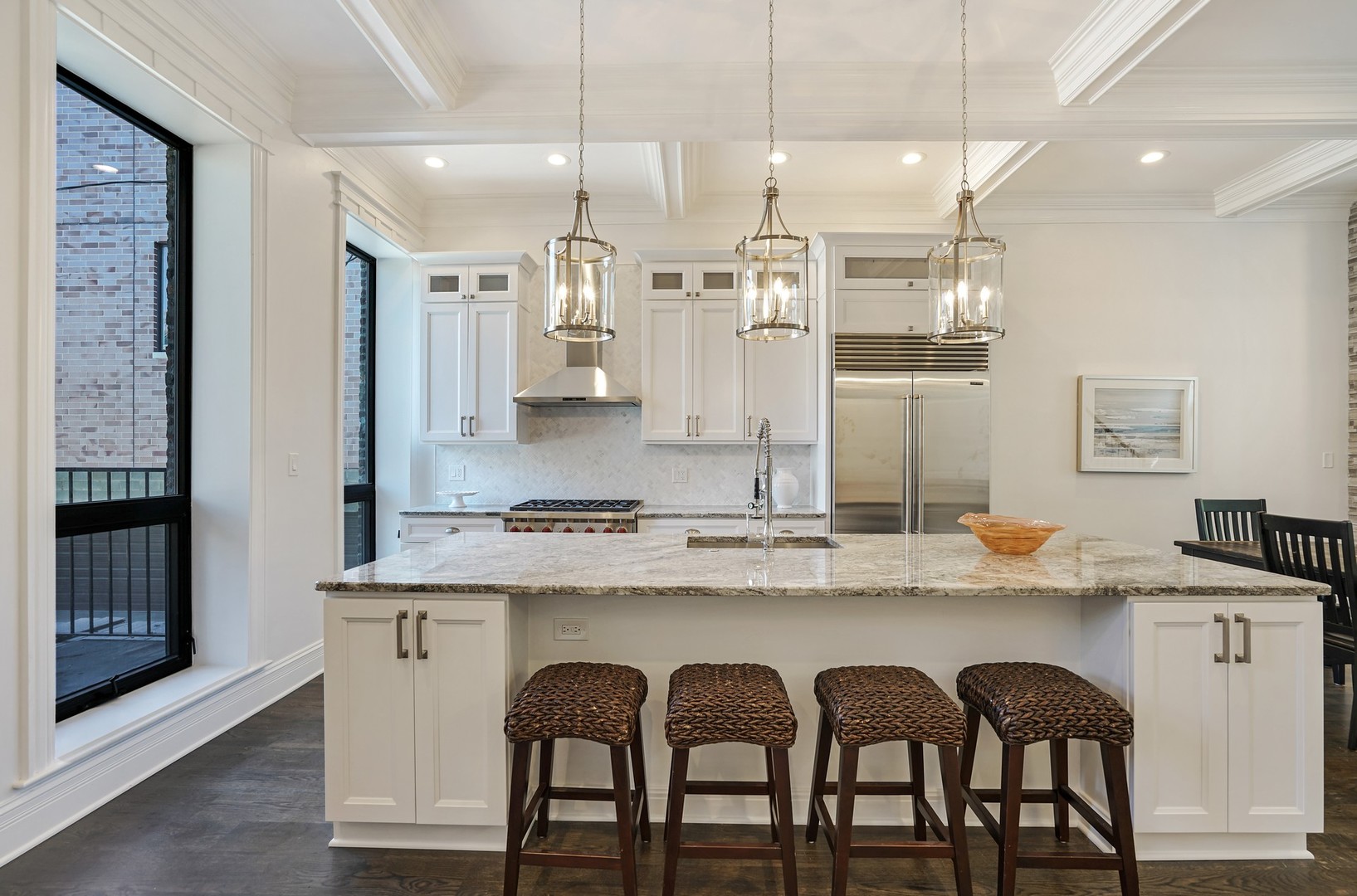 9 North Ada Street Chicago, IL 60607 - Photo 7 of 39 a kitchen with stainless steel appliances granite countertop a dining table chairs sink and cabinets
