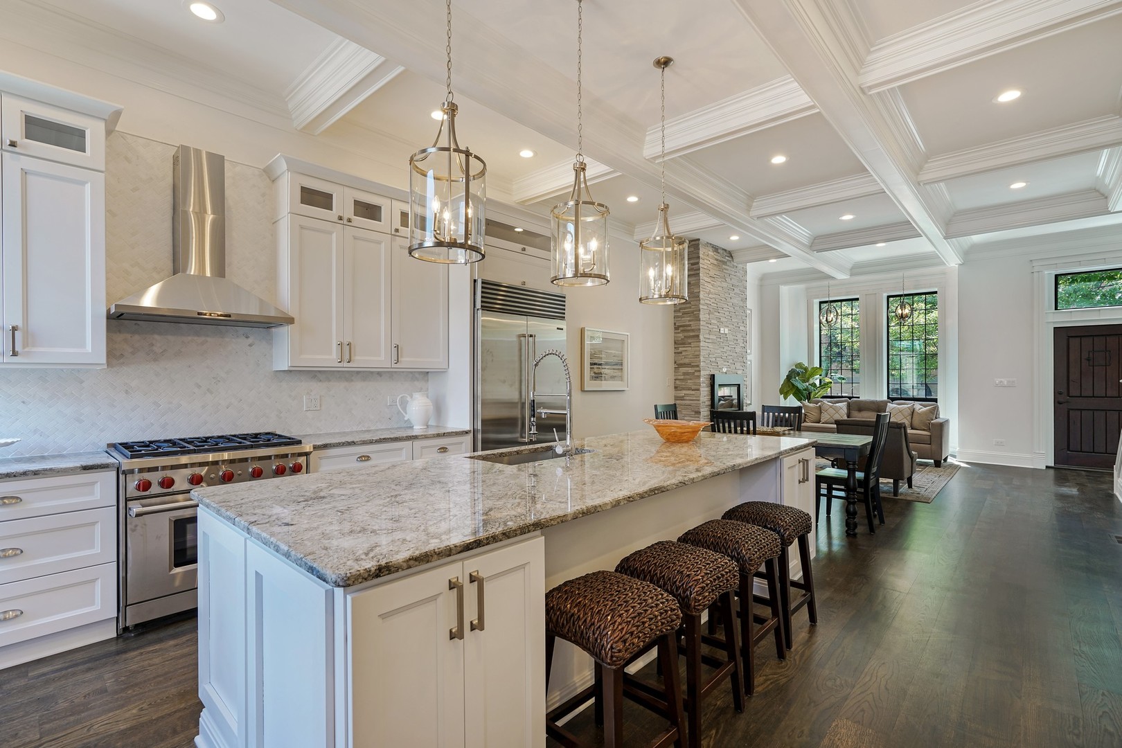 9 North Ada Street Chicago, IL 60607 - Photo 8 of 39 a kitchen with granite countertop a stove a sink a dining table and chairs with wooden floor