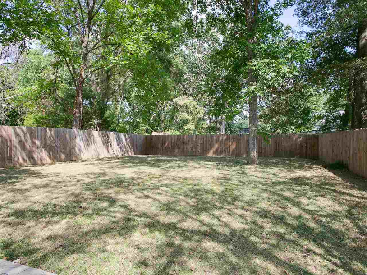 1204 North Roxboro Street Durham, NC 27701 - Photo 27 of 30 Large and flat fenced backyard with patio and mature landscaping.