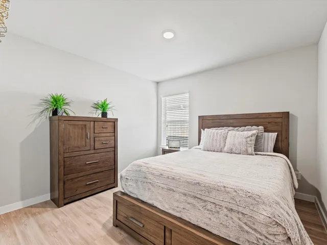 a workspace with furniture wall paintings and a window