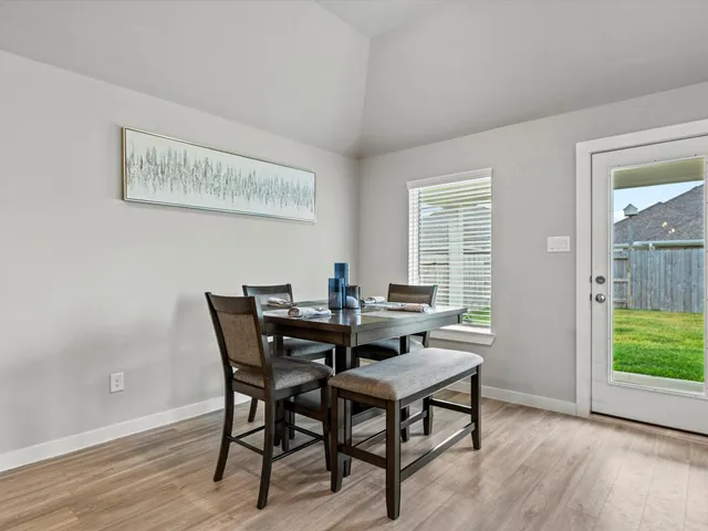 a kitchen with a sink a counter top space and living room view