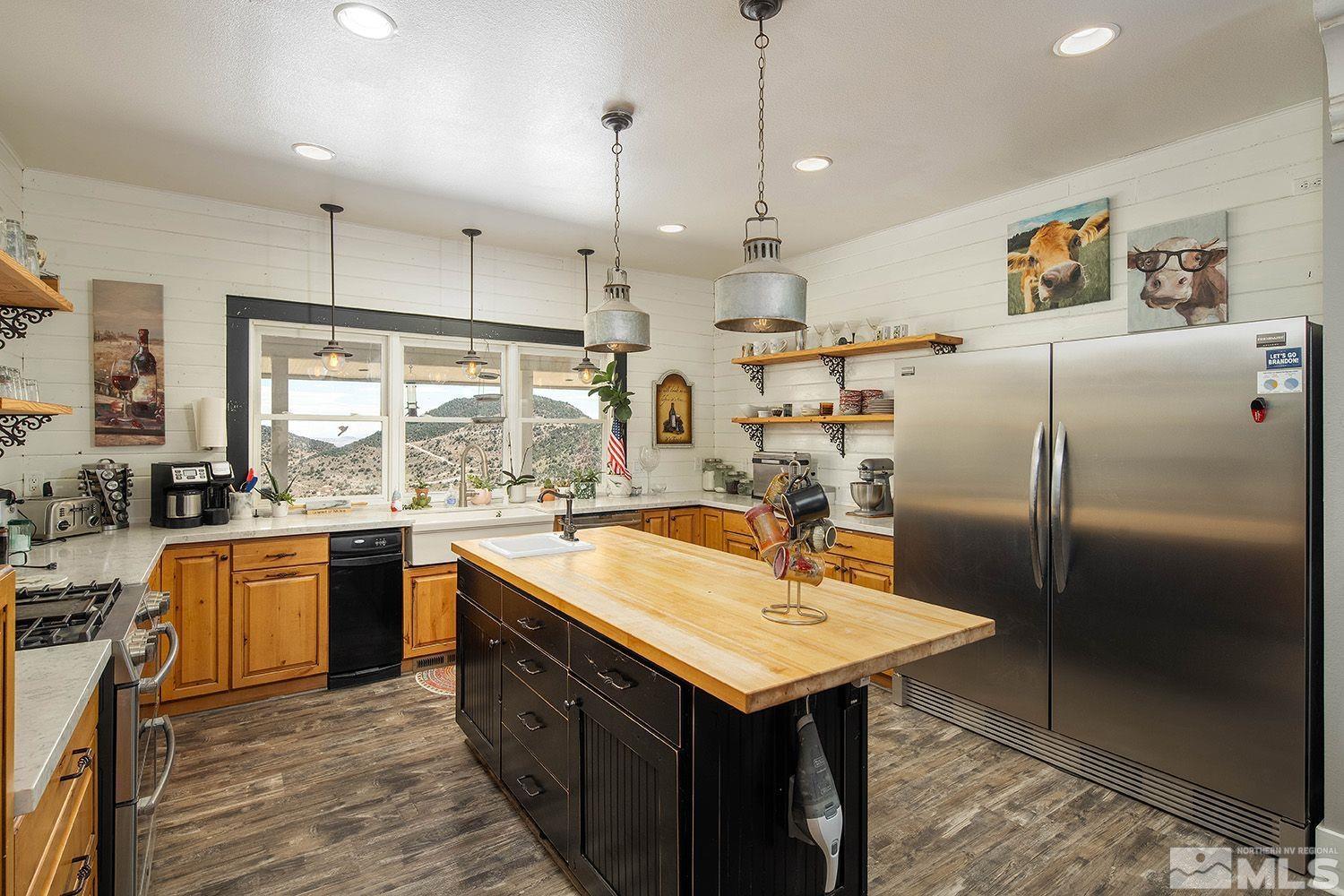 8000 Geiger Grade Road Reno, NV 89521 - Photo 7 of 28 a kitchen with stainless steel appliances granite countertop a sink a stove and a refrigerator