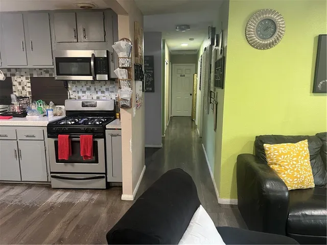 a kitchen with a refrigerator a stove top oven a sink and dishwasher