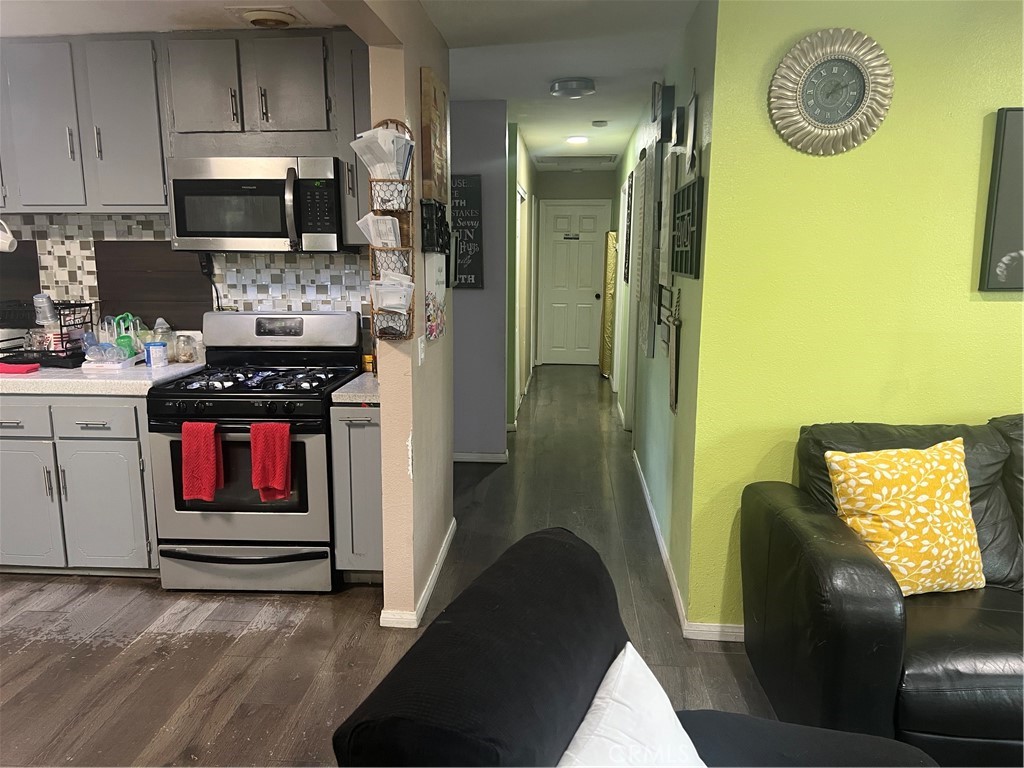 8943 Delano Drive Riverside, CA 92503 - Photo 3 of 11 a kitchen with a refrigerator a stove top oven a sink and dishwasher