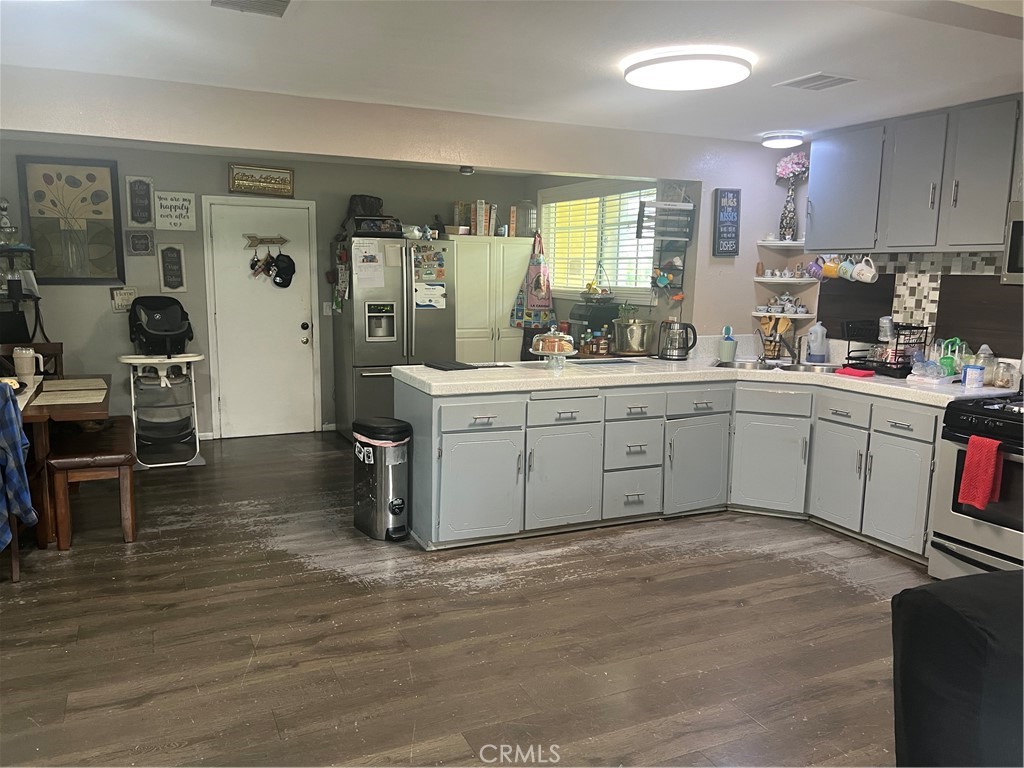 8943 Delano Drive Riverside, CA 92503 - Photo 4 of 11 a kitchen with a sink cabinets and wooden floor