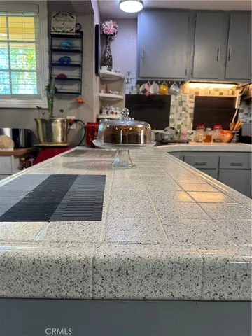 a kitchen with kitchen island granite countertop a sink counter top space and cabinets