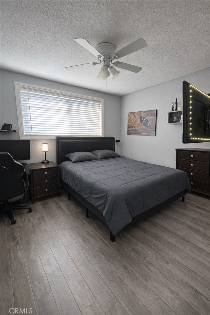 8943 Delano Drive Riverside, CA 92503 - Photo 7 of 12 a bedroom with a bed window and a flat screen tv