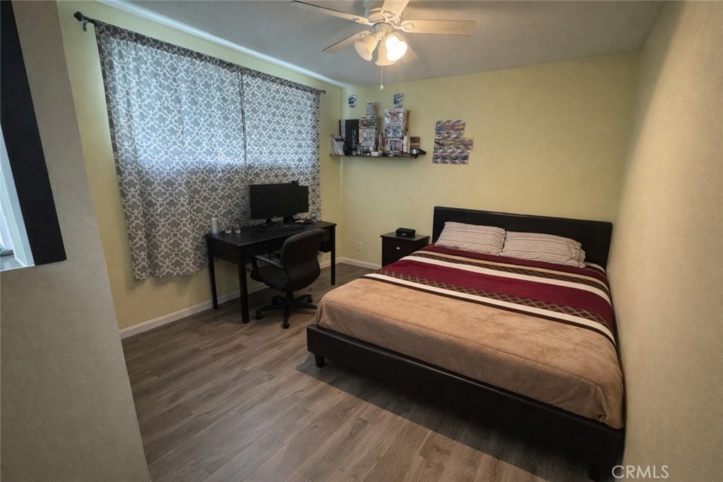 8943 Delano Drive Riverside, CA 92503 - Photo 9 of 12 a bedroom with a bed and a desk