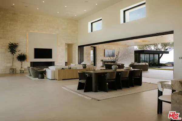 a living room with furniture flat screen tv and couches