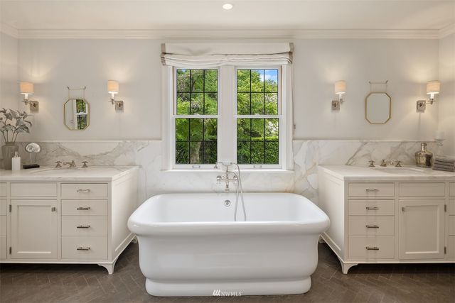 a spacious bathroom with a bathtub and a sink