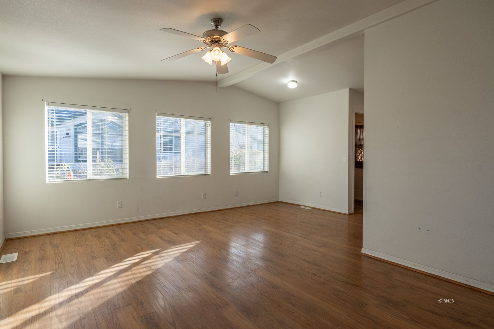 231 West Street Big Pine, CA 93513 - Photo 8 of 23 a view of an empty room with a window and wooden floor