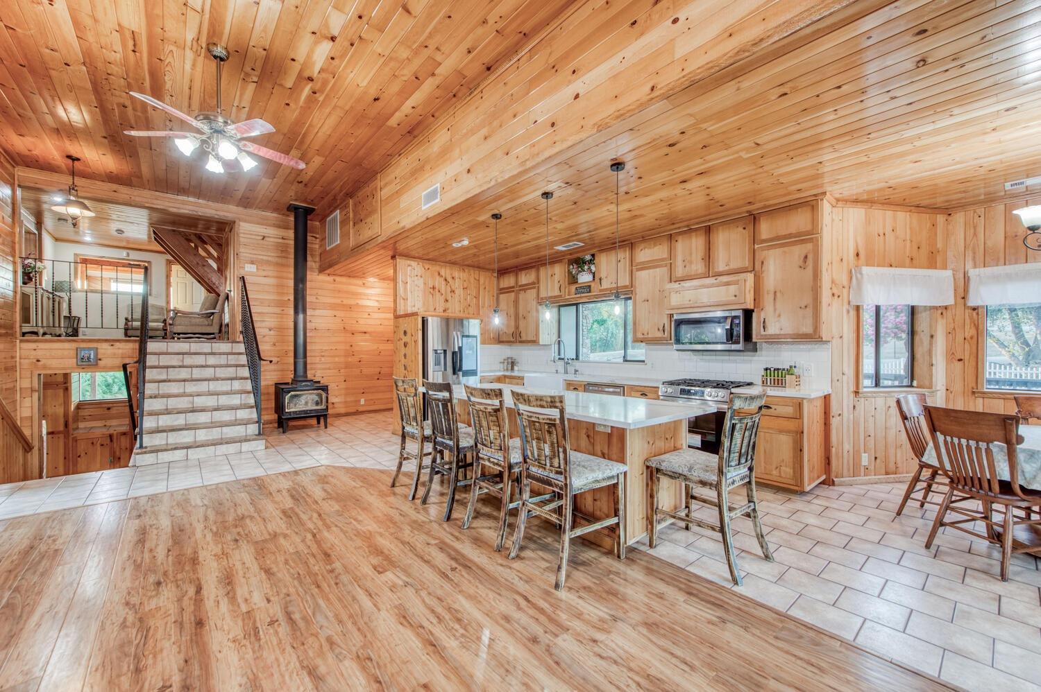 49376 House Ranch Road O'Neals, CA 93645 - Photo 16 of 70 a dining room with stainless steel appliances kitchen island granite countertop a table chairs and a chandelier