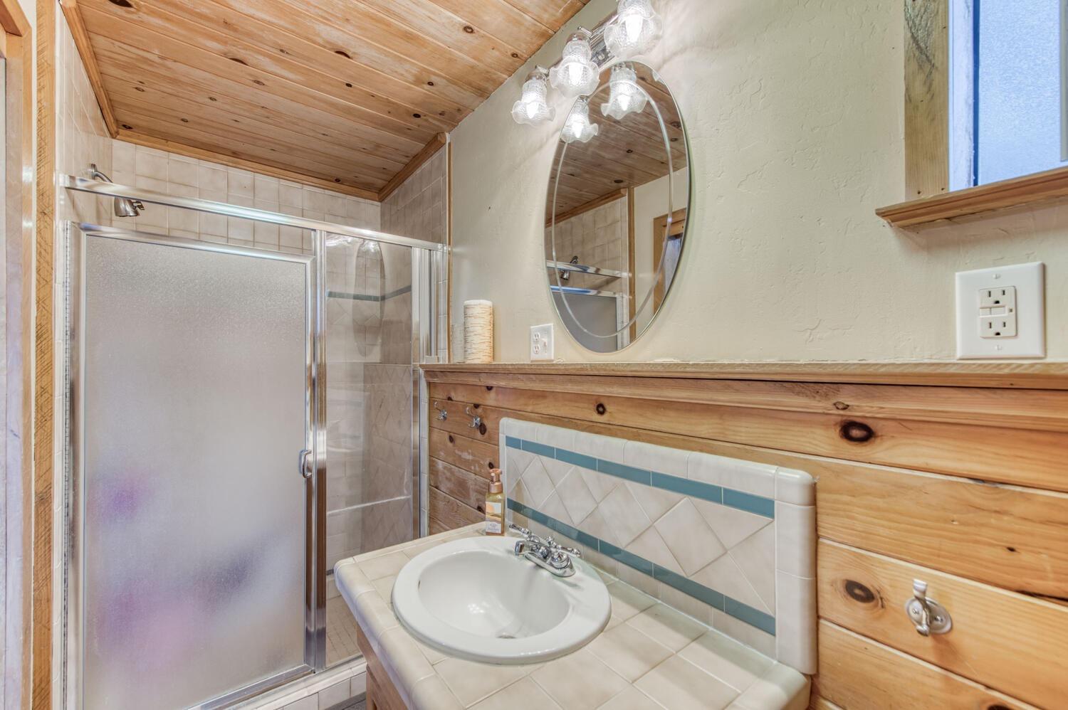 49376 House Ranch Road O'Neals, CA 93645 - Photo 24 of 70 a bathroom with a sink a mirror and a shower