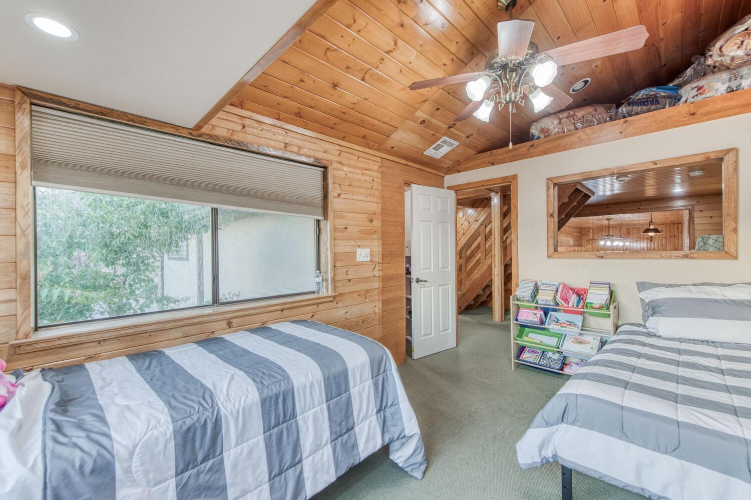 49376 House Ranch Road O'Neals, CA 93645 - Photo 33 of 70 a bedroom with a bed ceiling fan and a large window