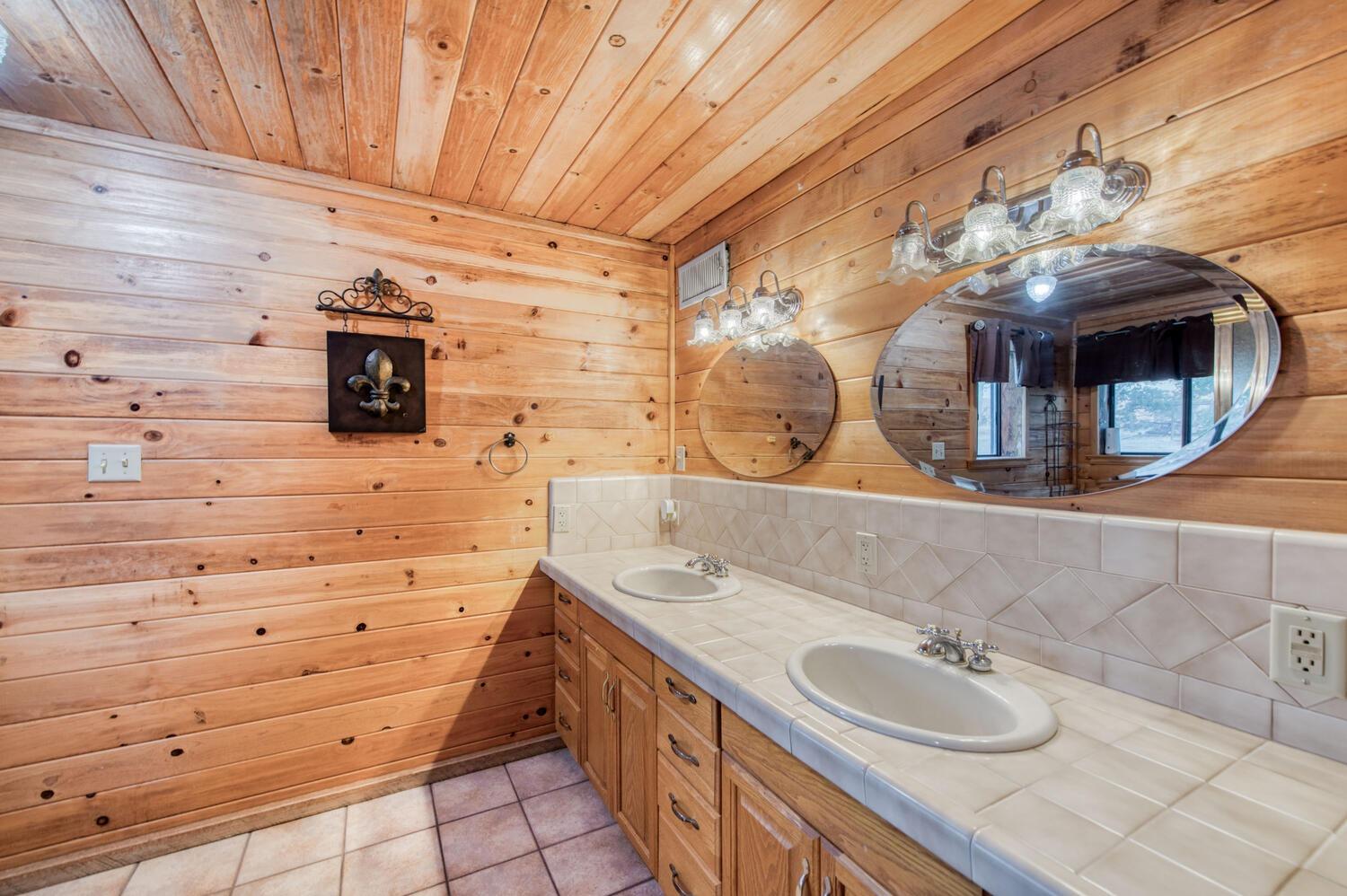 49376 House Ranch Road O'Neals, CA 93645 - Photo 37 of 70 a bathroom with a double vanity sink and a mirror