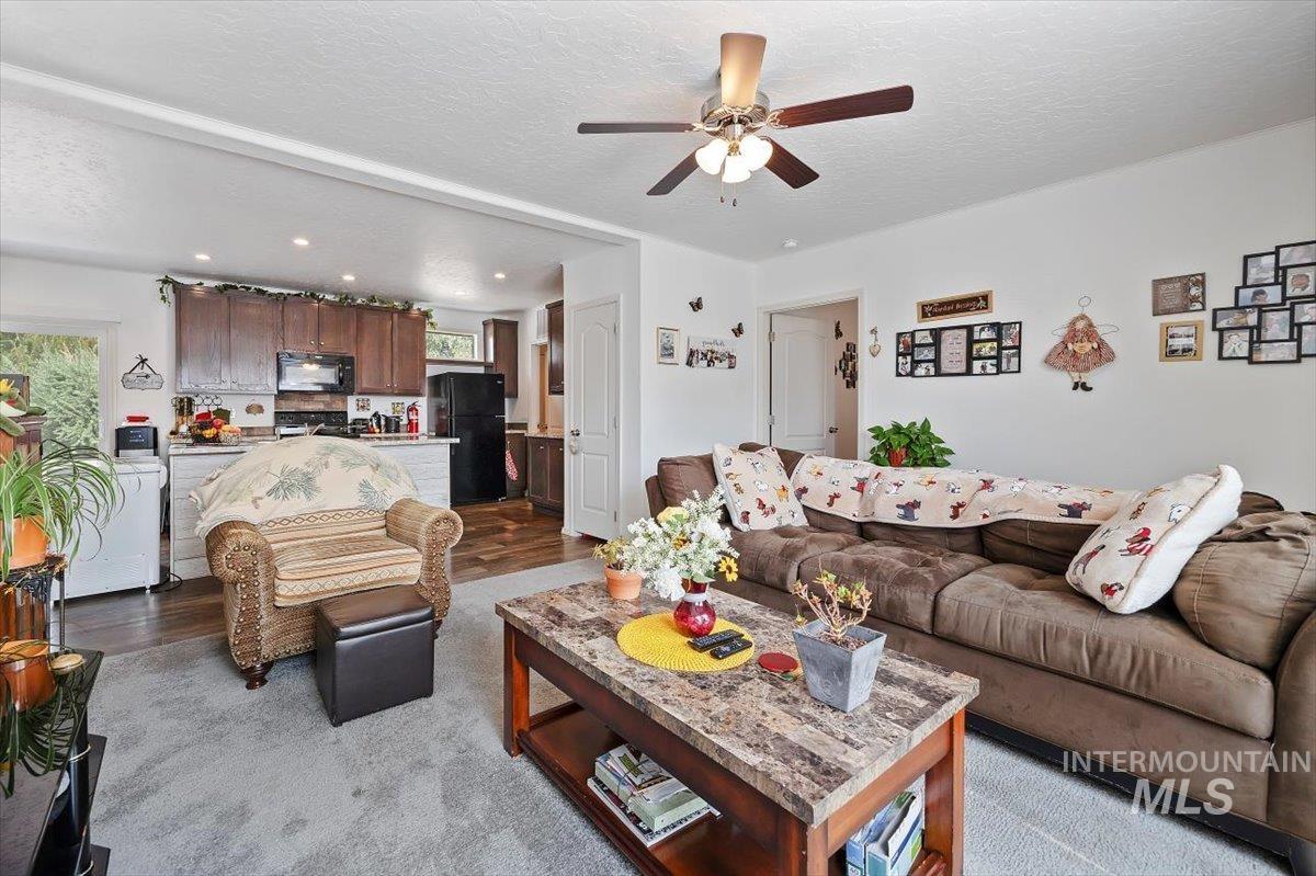 121 Sunset Drive North Hagerman, ID 83332 - Photo 6 of 31 Living area with dark wood finished floors, a textured ceiling, ceiling fan, and recessed lighting