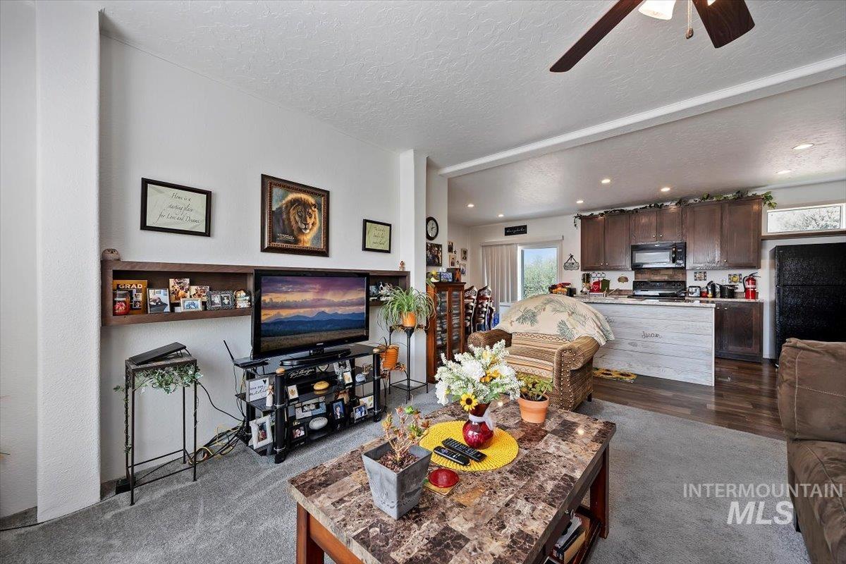 121 Sunset Drive North Hagerman, ID 83332 - Photo 7 of 31 Living room with dark carpet, ceiling fan, a textured ceiling, and recessed lighting