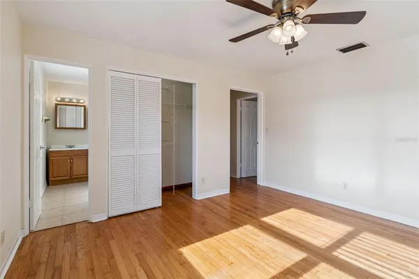 a view of a livingroom with a ceiling fan and hardwood floor