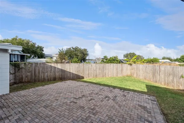 a view of a backyard with wooden fence