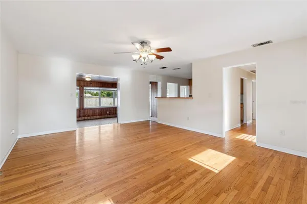 wooden floor in an empty room with a window