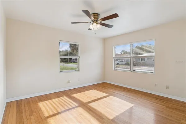 a view of a room with window and ceiling fan