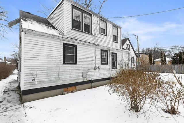 a view of a house with a snow in the yard