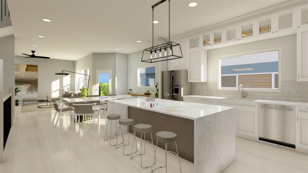 a kitchen with a table chairs and white cabinets
