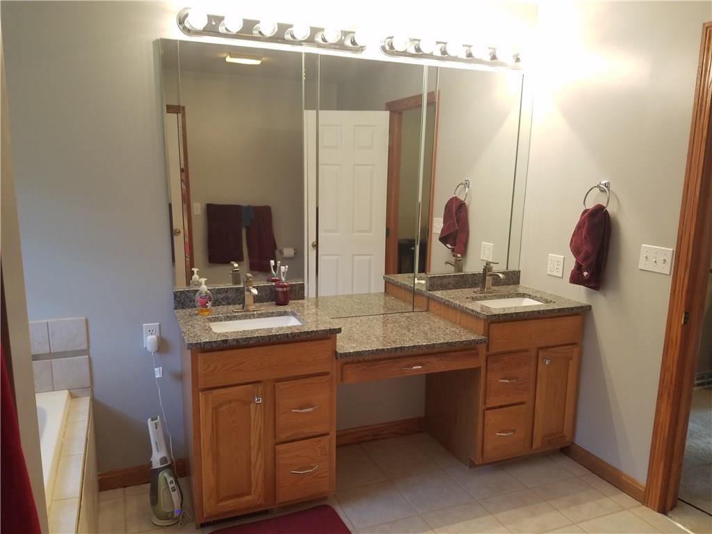 244 North Road Butler, PA 16001 - Photo 10 of 24 Double sinks with new granite counter tops in master bath. Bathroom also has new tile floor and bathtub surround.