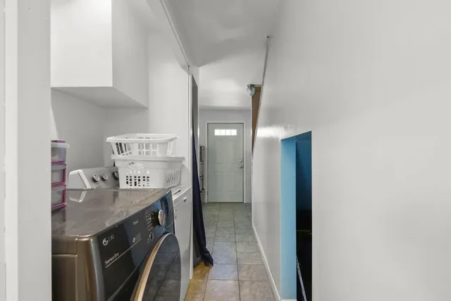a kitchen with stainless steel appliances granite countertop a sink and a refrigerator
