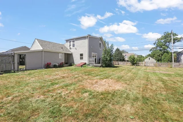 a front view of house with yard and trees around