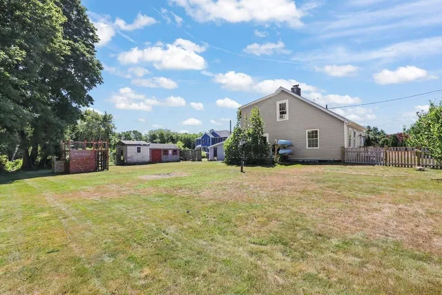 a front view of house with yard and trees