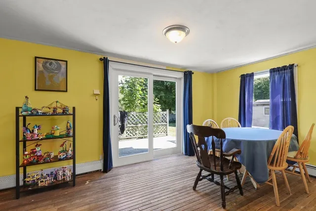 a view of a dining room with furniture and window