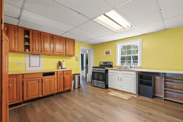 a kitchen with stainless steel appliances granite countertop a stove sink and cabinets