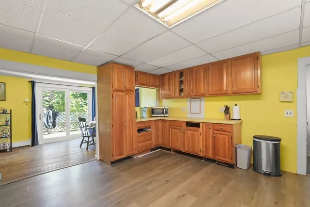 a kitchen with lots of counter top space and wooden floor