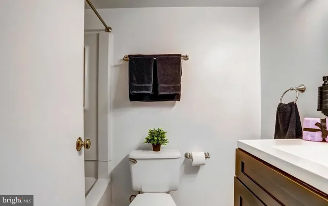 a bathroom with a toilet a sink and shower