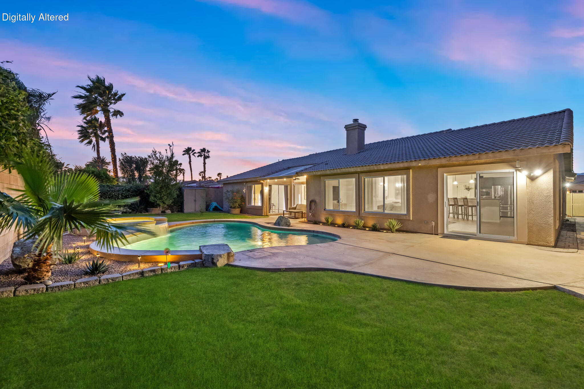 80543 Philadelphia Avenue Indio, CA 92201 - Photo 1 of 46 a view of a house with a swimming pool and a yard