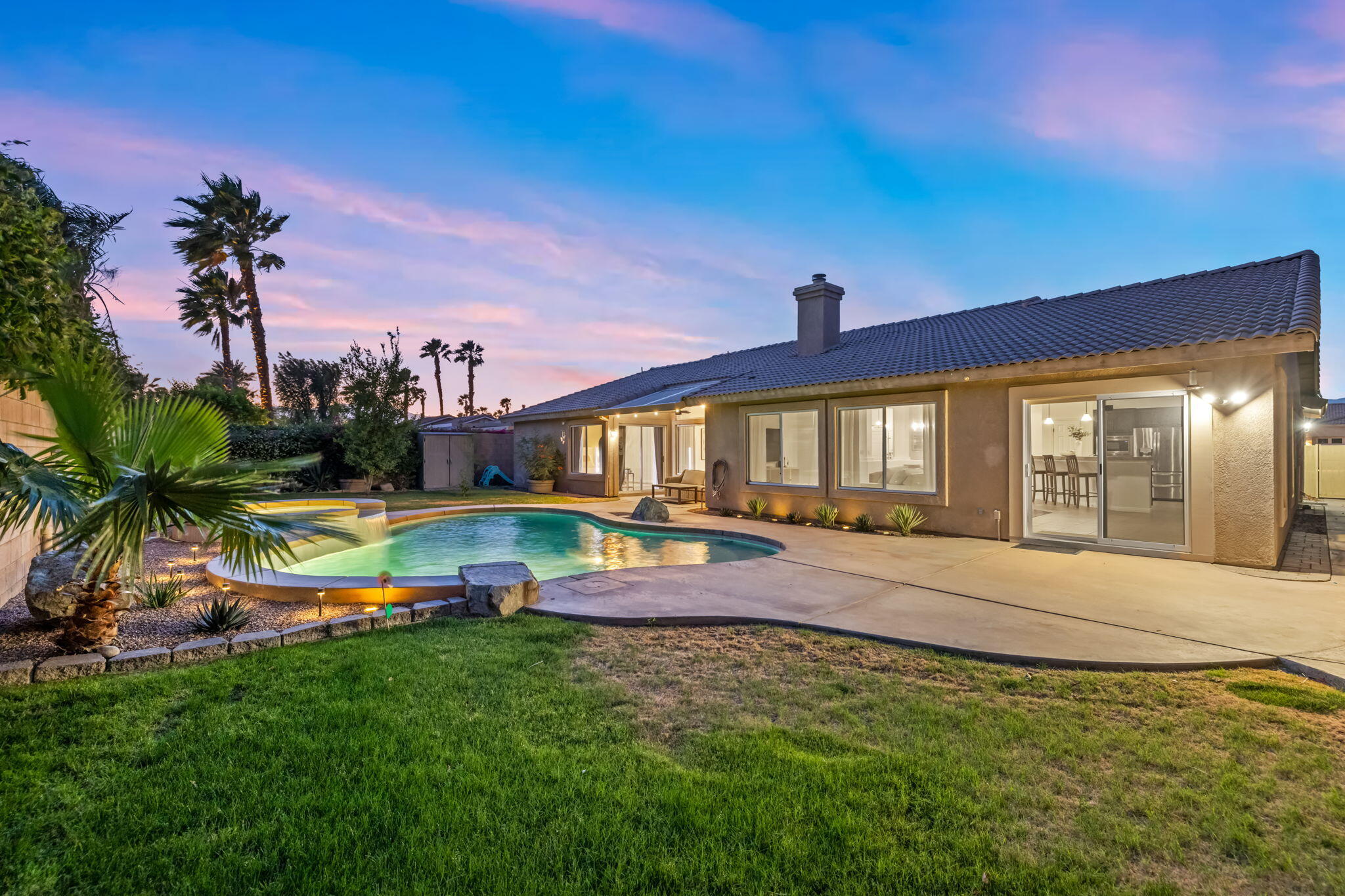 80543 Philadelphia Avenue Indio, CA 92201 - Photo 2 of 46 a view of swimming pool with outdoor seating and house in the background