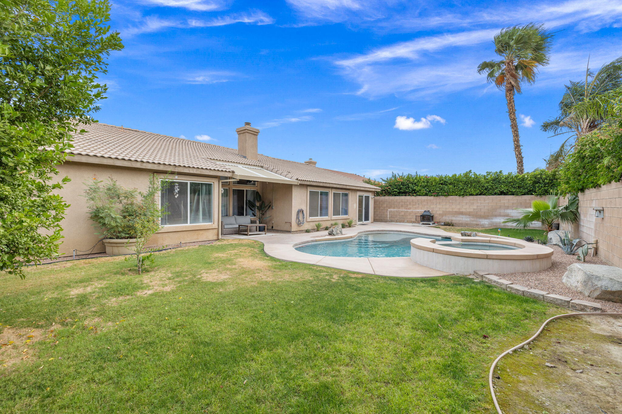 80543 Philadelphia Avenue Indio, CA 92201 - Photo 38 of 46 a view of a house with swimming pool and sitting area