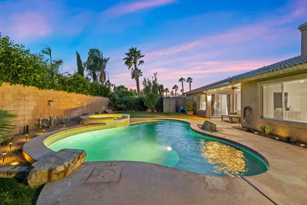 swimming pool with outdoor seating and yard