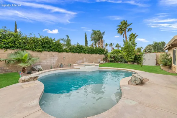 a view of a swimming pool with an outdoor space and seating area