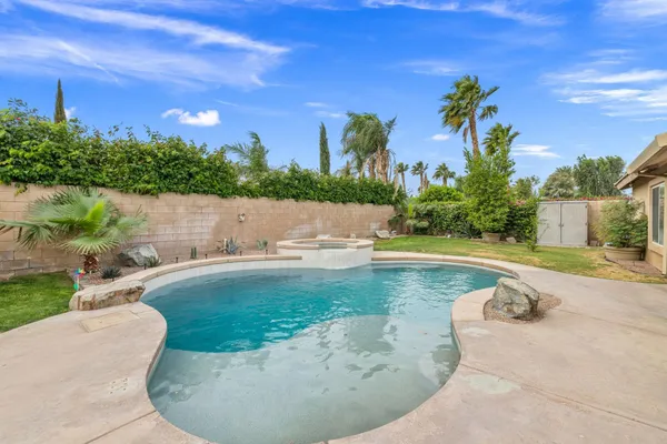 a view of a swimming pool with an outdoor space and seating area