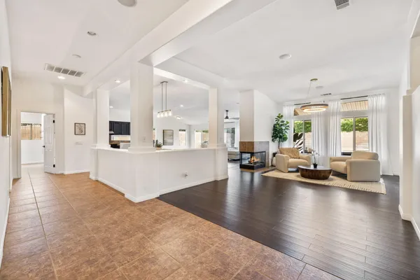 a large white kitchen with a large window and stainless steel appliances