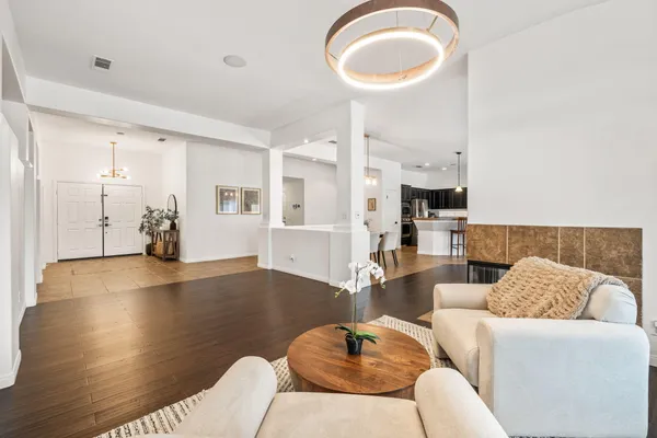 a living room with furniture and wooden floor
