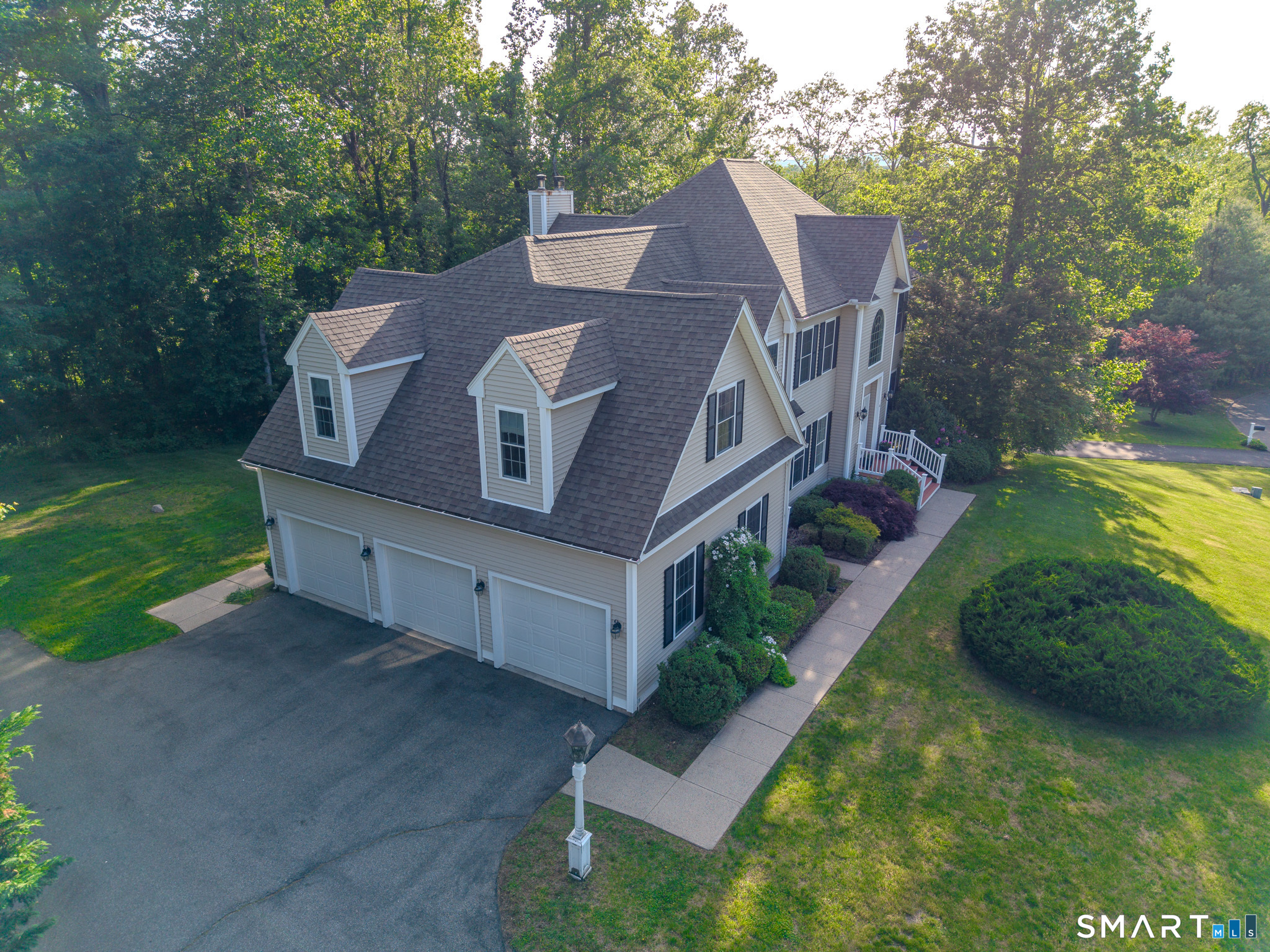 4 Ortense Road Wallingford, CT 06492 - Photo 4 of 33 a aerial view of a house with a yard table and chairs