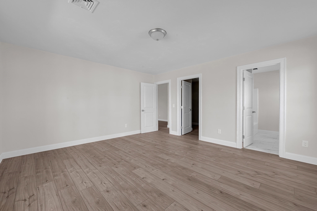 7 L Stevens Road, Unit A Charlton, MA 01507 - Photo 14 of 23 a view of an empty room with wooden floor and closet