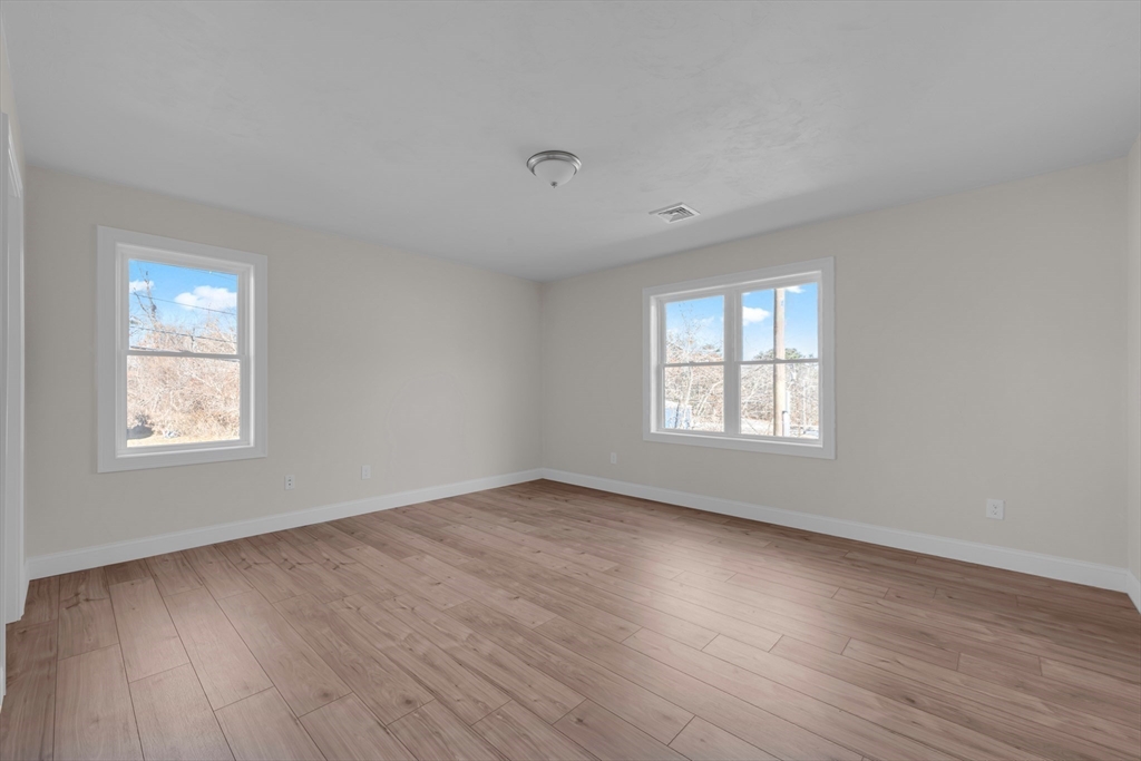 7 L Stevens Road, Unit A Charlton, MA 01507 - Photo 16 of 23 a view of an empty room with wooden floor and a window