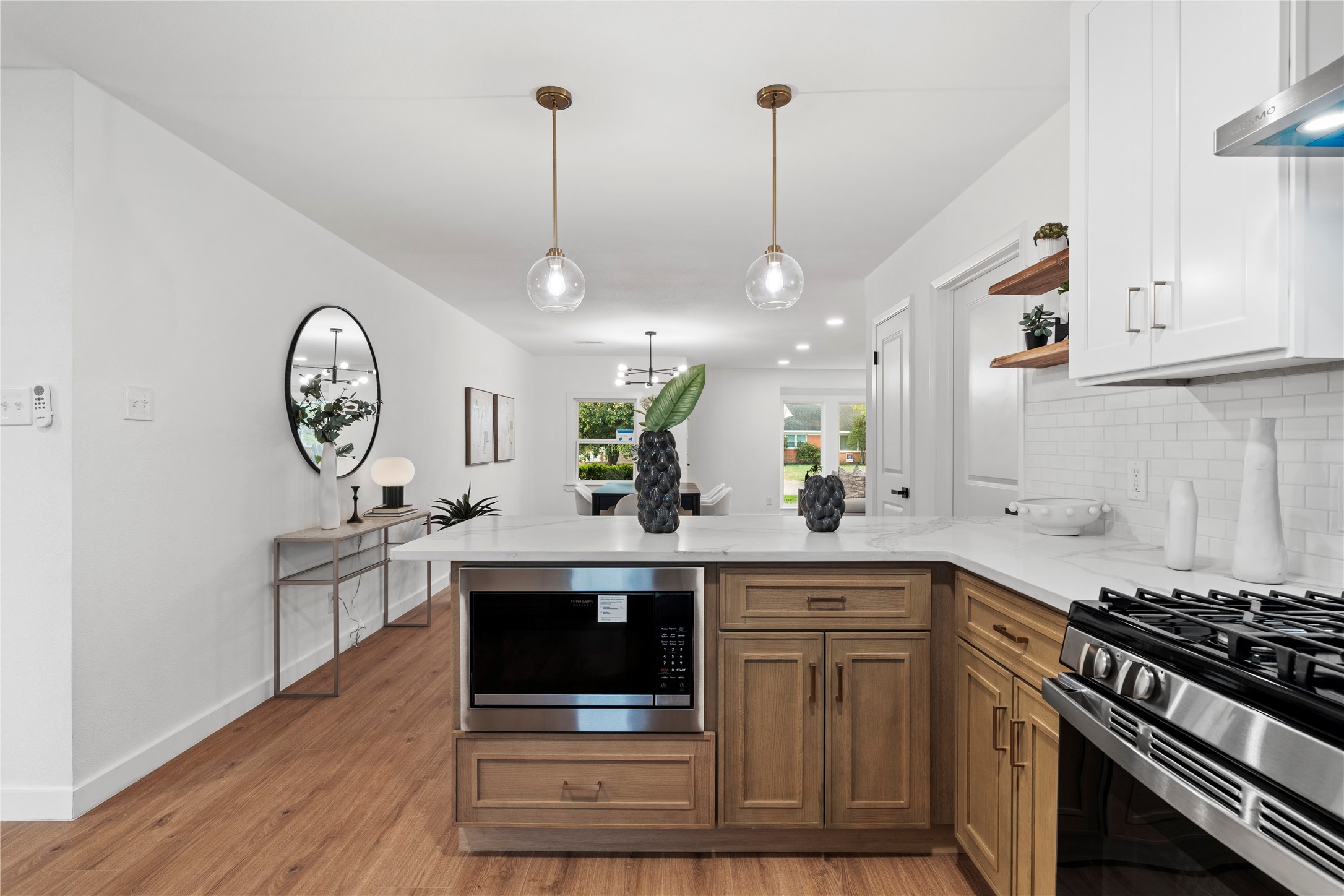 5023 Redstart Street Houston, TX 77035 - Photo 18 of 34 This sophisticated kitchen view showcases the convenient built-in microwave drawer and sleek two-toned cabinetry that seamlessly integrates with the open-concept living area.