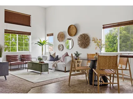 a living room filled with furniture and a large window