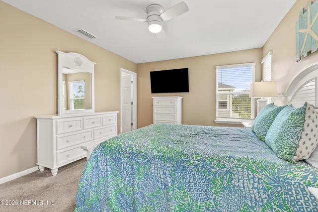 a bedroom with a bed a window and a television