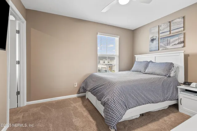 a bedroom with a bed and a window